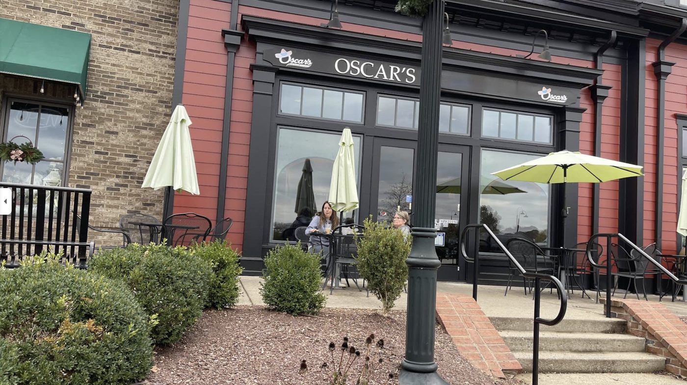 Guests at a patio table outside an Oscar's Fresh Mex